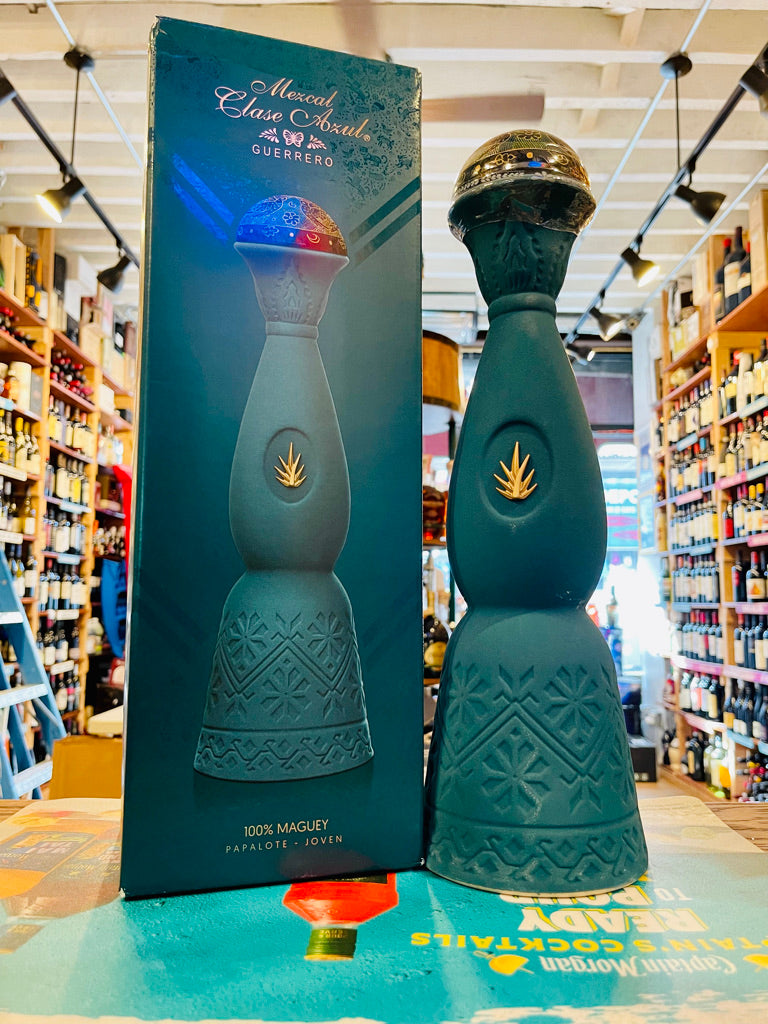 Clase Azul Mezcal Guerrero 750mL a tall elegantly designed green bottle with a silver bell topper next to a green tall box