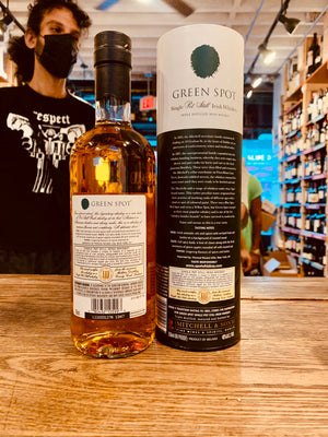 Green Spot Single Pot Still Irish Whiskey 750mL the backside of a short rounded high shouldered bottle with a white label and green spot on it, next to a tall white and green tin cylinder.