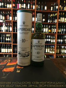 Laphroaig Scotch Single Malt 10yr Old 86º 750ml a tall cylinder white in color next to a green clear glass bottle with a white label and white top