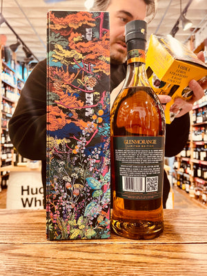Glenmorangie Tale of the Forest 750mL a tall green box with a floral image on it next to the backside of a tall shapely clear bottle with a green label and green top
