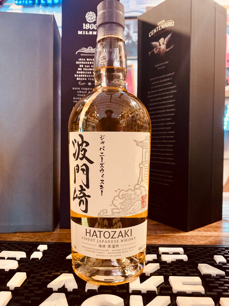 Hatozaki Finest Japanese Whisky 750mL a clear tall rounded shouldered bottle with a white label and light gray top