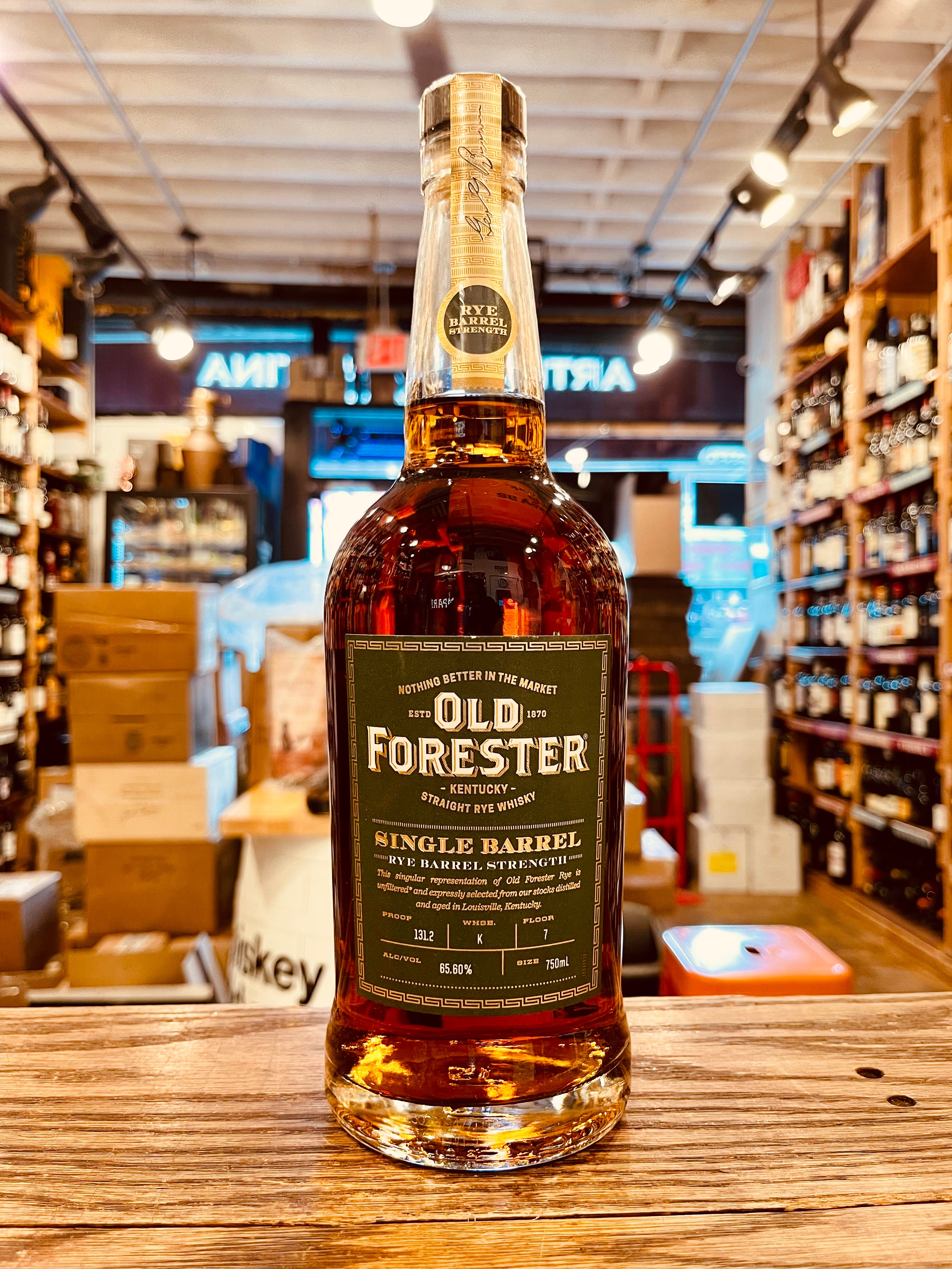 Old Forester Single Barrel Rye Barrel Proof 750mL a tall high shouldered clear glass bottle with a green label and wooden top