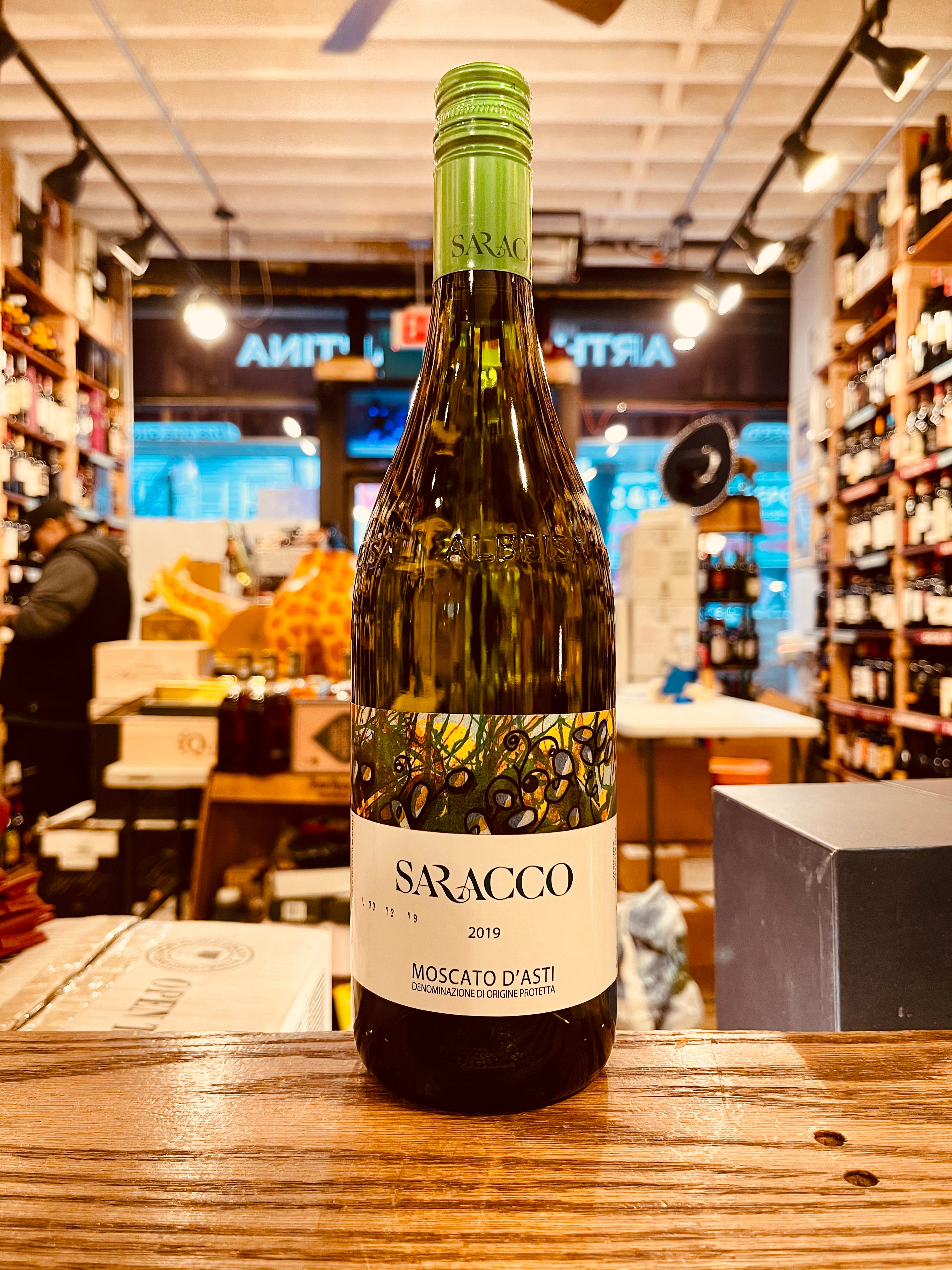Saracco Moscato D'Asti 750ml a straw colored glass wine bottle with a white and green label and green top