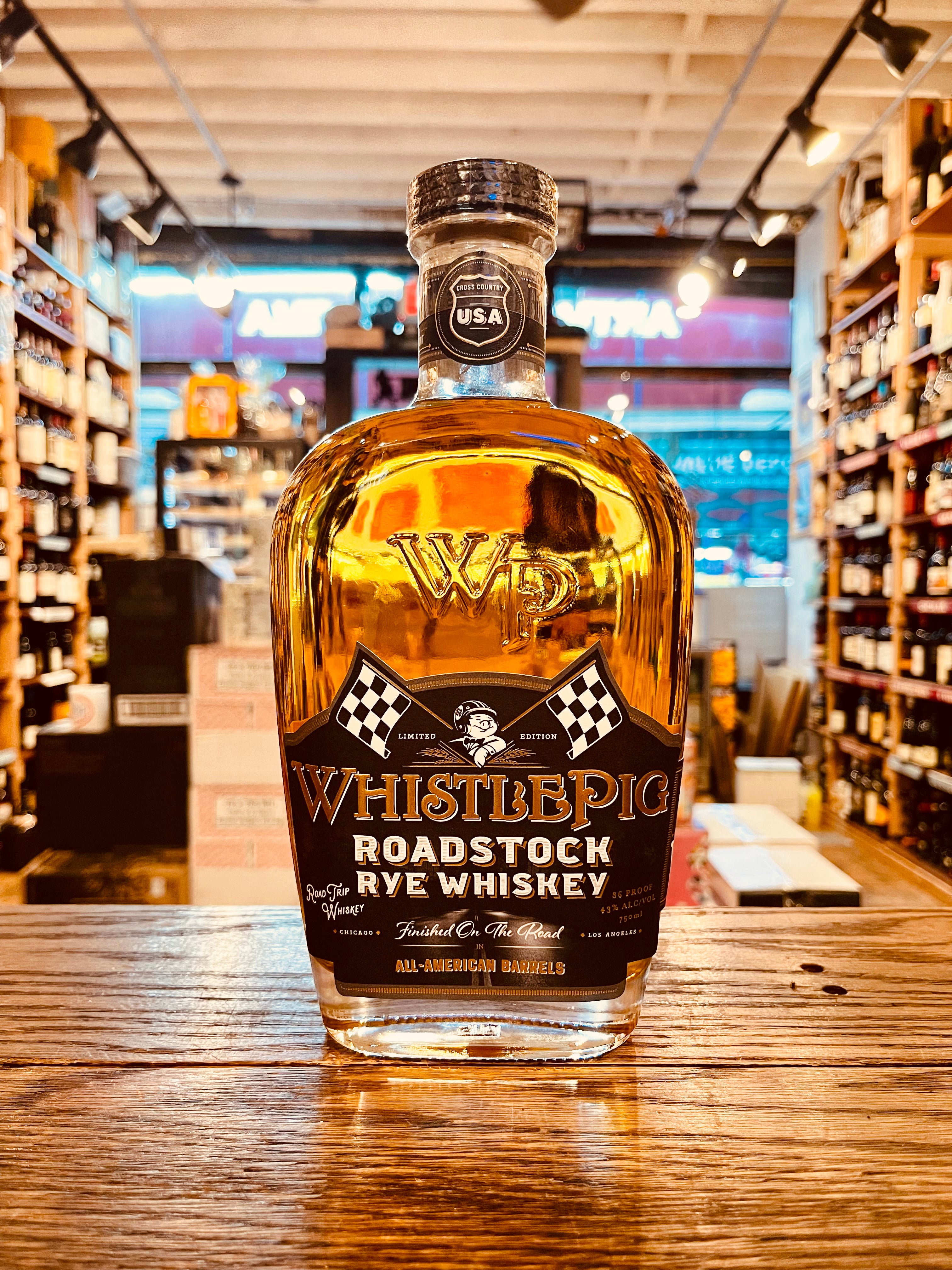 Whistle Pig Roadstock Rye Whiskey 750mL a robustly shaped clear glass bottle with a black label and a wooden top