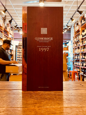 Glenmorangie 1997 Bond House No.1 750mL a tall wooden box with a reflective golden boarder and white lettering 
