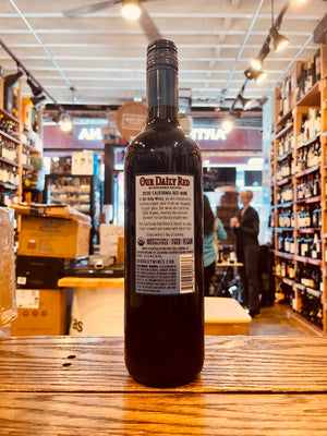 Our Daily Red 750mL Vegan the backside of a dark wine bottle with a blue label and a blue top
