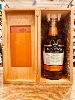 Midleton Very Rare Whiskey Dair Ghaelach Kylebeg Wood Tree No3 700mL an open wooden box with an orange leaflet on one side and a clear high rounded shouldered glass bottle with a white label and wooden top