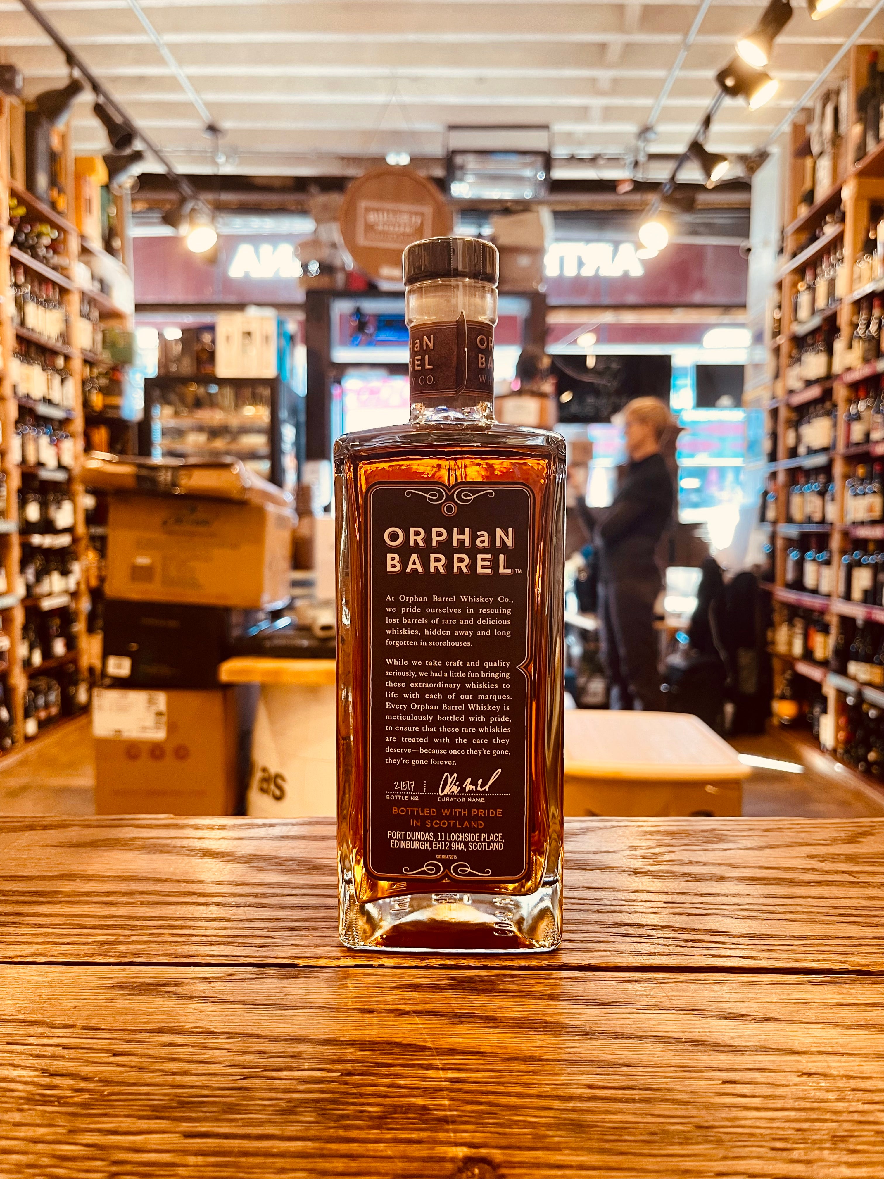 Orphan Barrel Muckety Muck 25YR Single Grain Scotch Whisky 750mL the sideview of a flat surfaced squared bottle with a black label