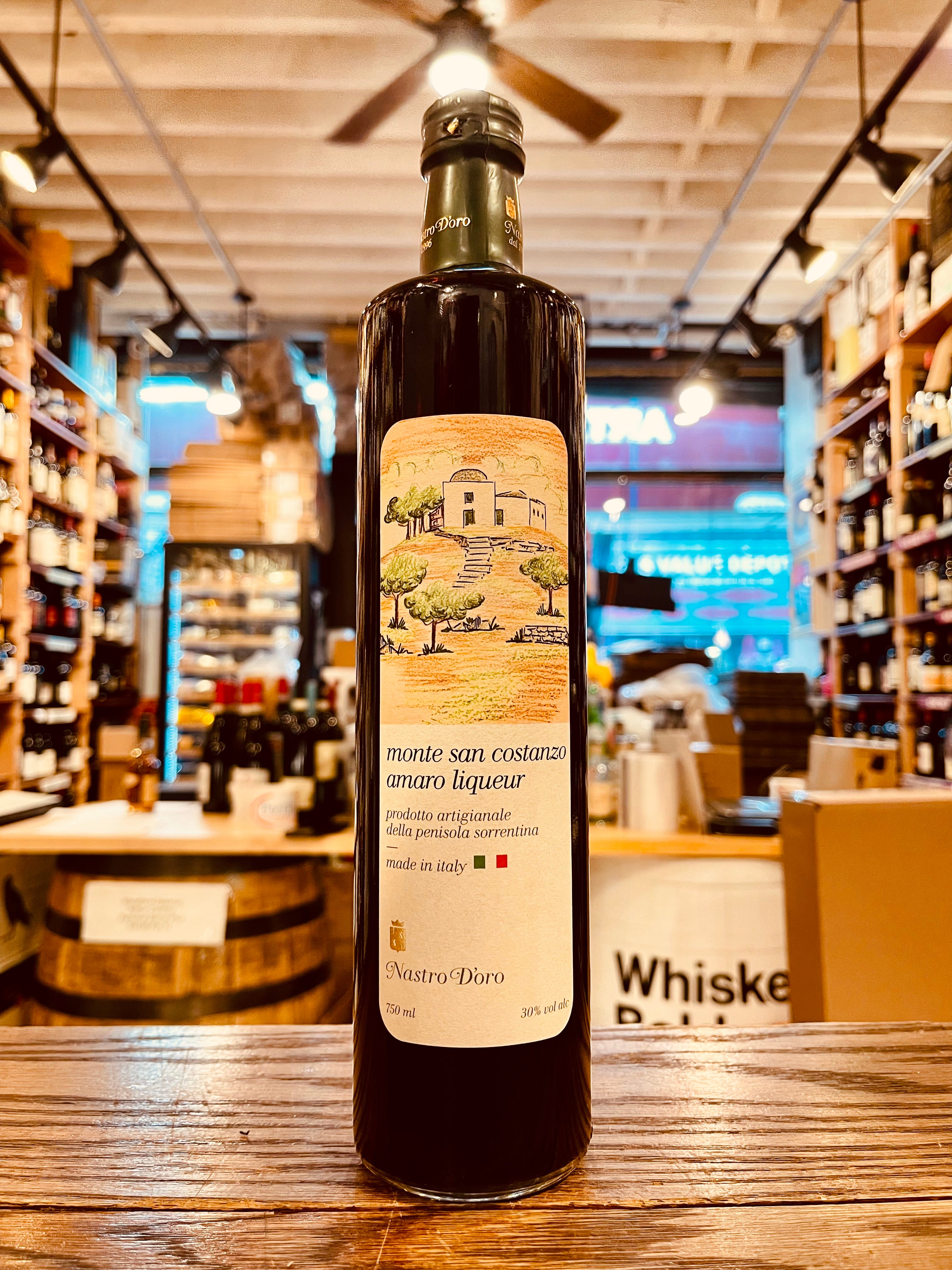 Amaro Monte San Costanzo Liqueuer 750mL tall elongated bottle with dark liquid and a white label