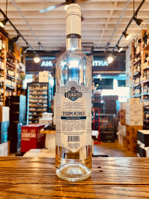 Loukatos Tsipouro Grape Distillate 750mL the backside of a tall slender clear glass bottle with a white label and a white top