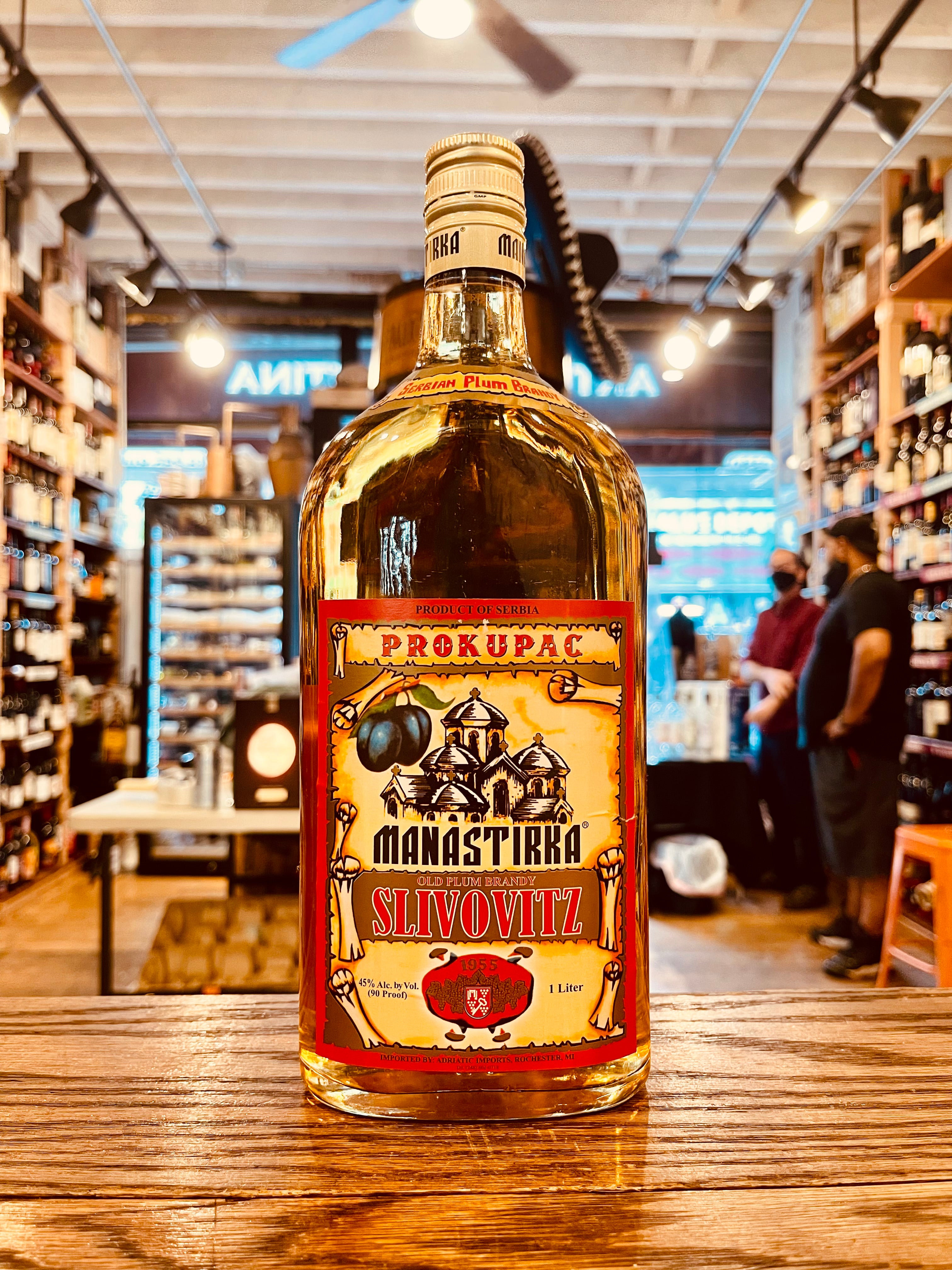 Manastirka Slivovitz 90º 1L 10yr old a flat surfaced squared bottle with a short neck with a yellow and red label with a golden top