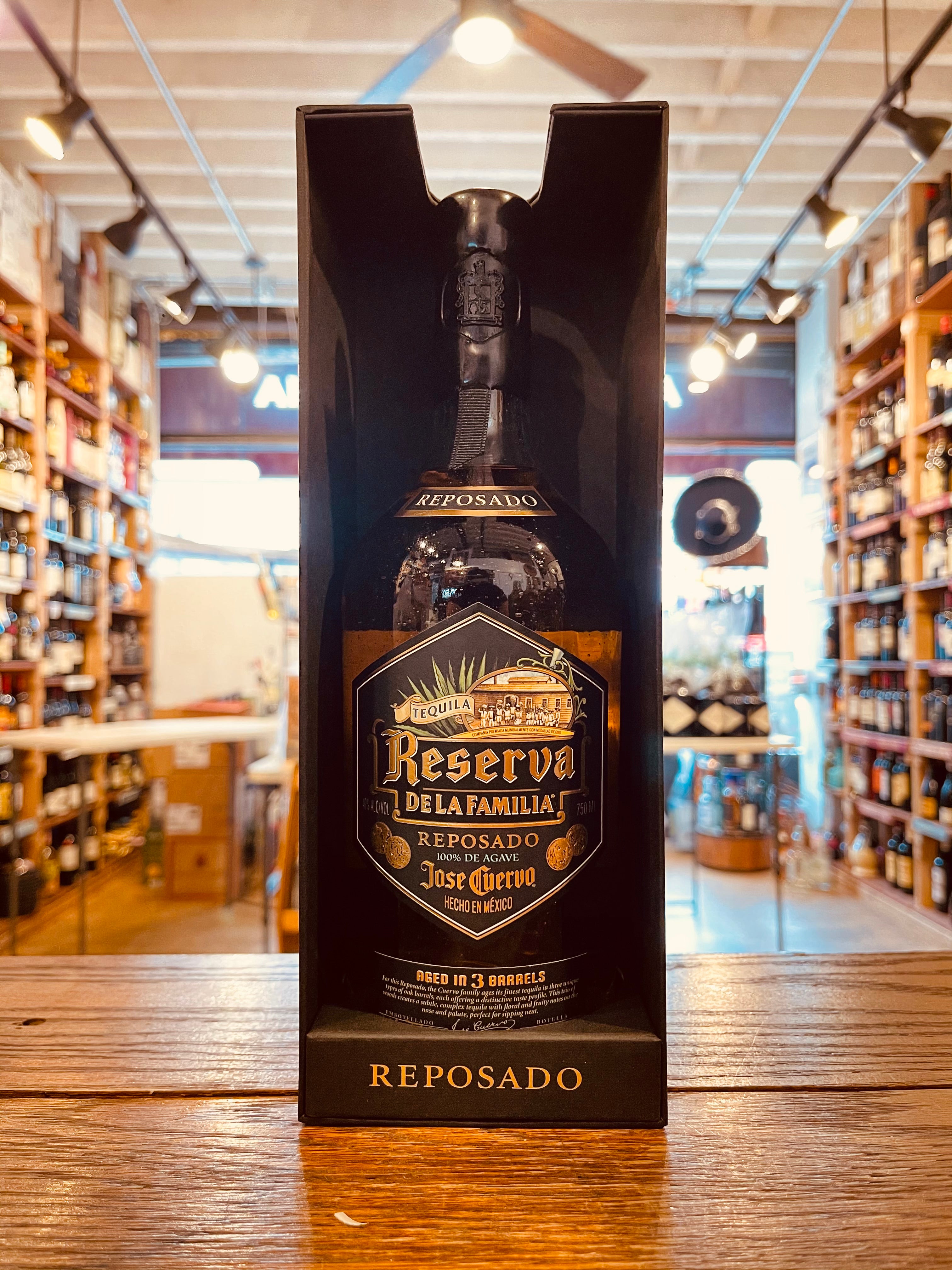 Reserva de la Familia Reposado 750mL an open black box with a dark glass high shouldered rounded bottle inside with a black and golden label and black wax top