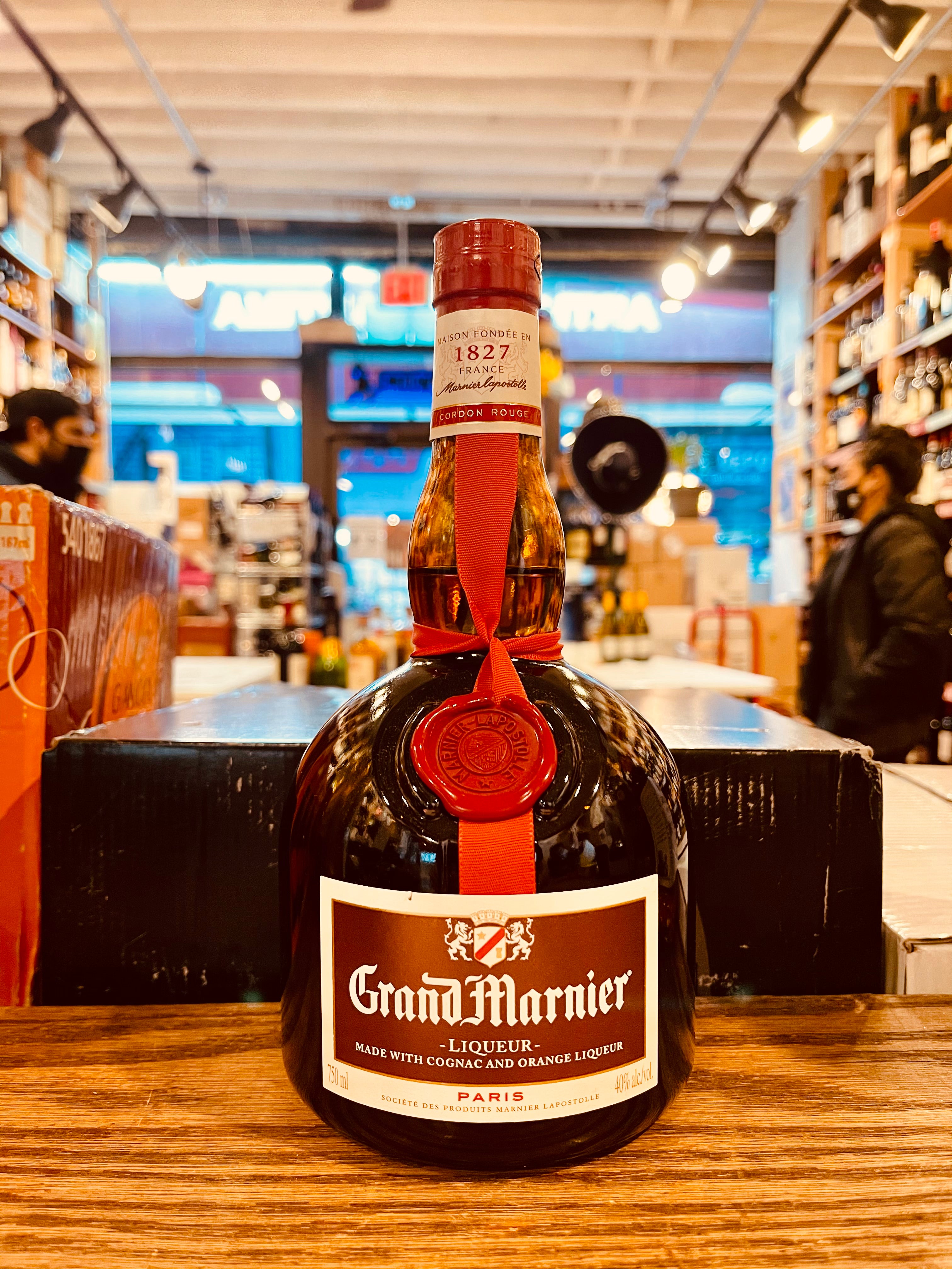 Grand Marnier 750ml short squat rounded bottle with a maroon label and red top