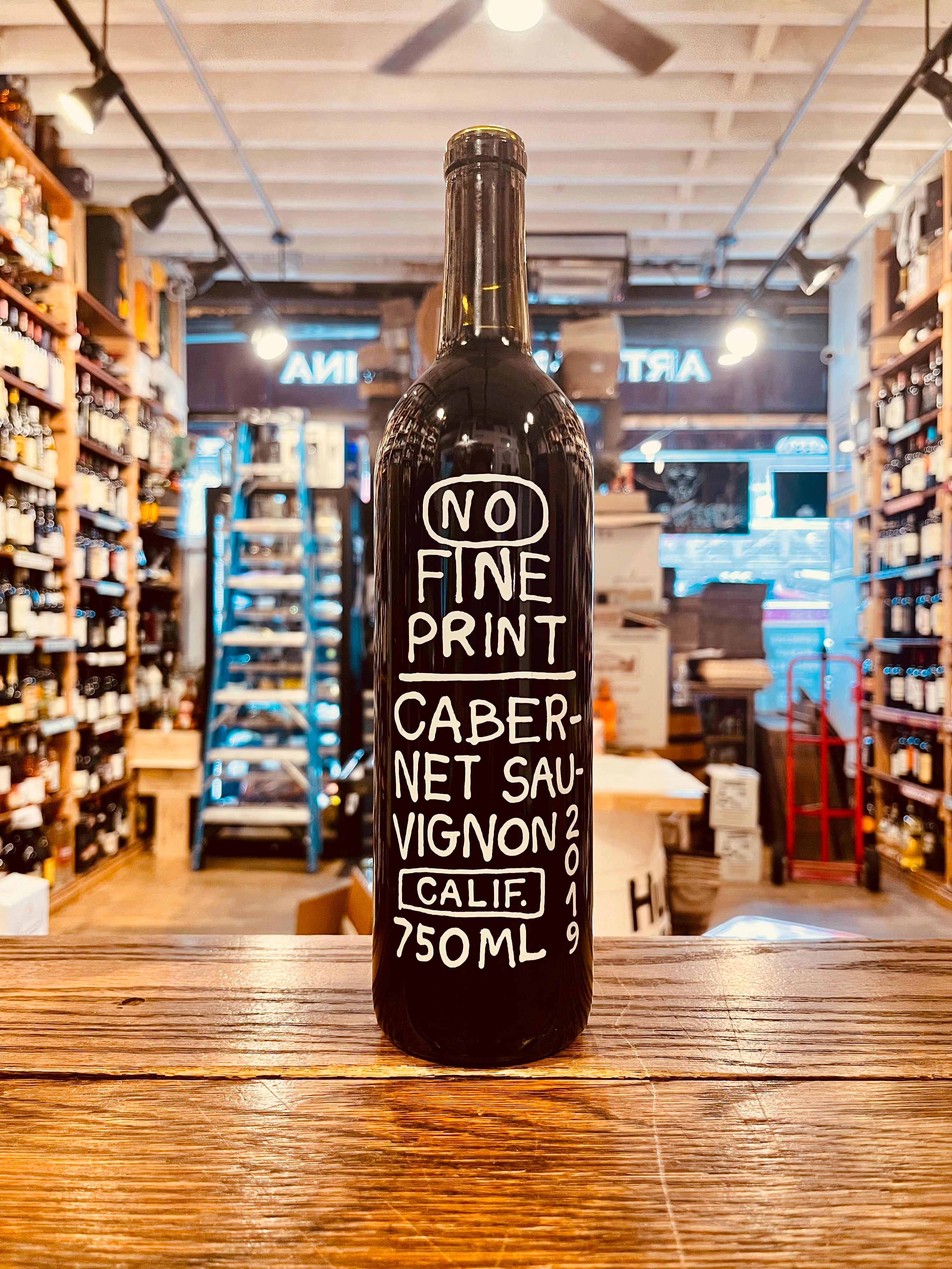 No Fine Print Cabernet 750mL a dark glass wine bottle with large white font and a black top