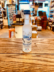 Grey Goose 50mL a small frosted glass bottle with the image of a goose on it and blue top