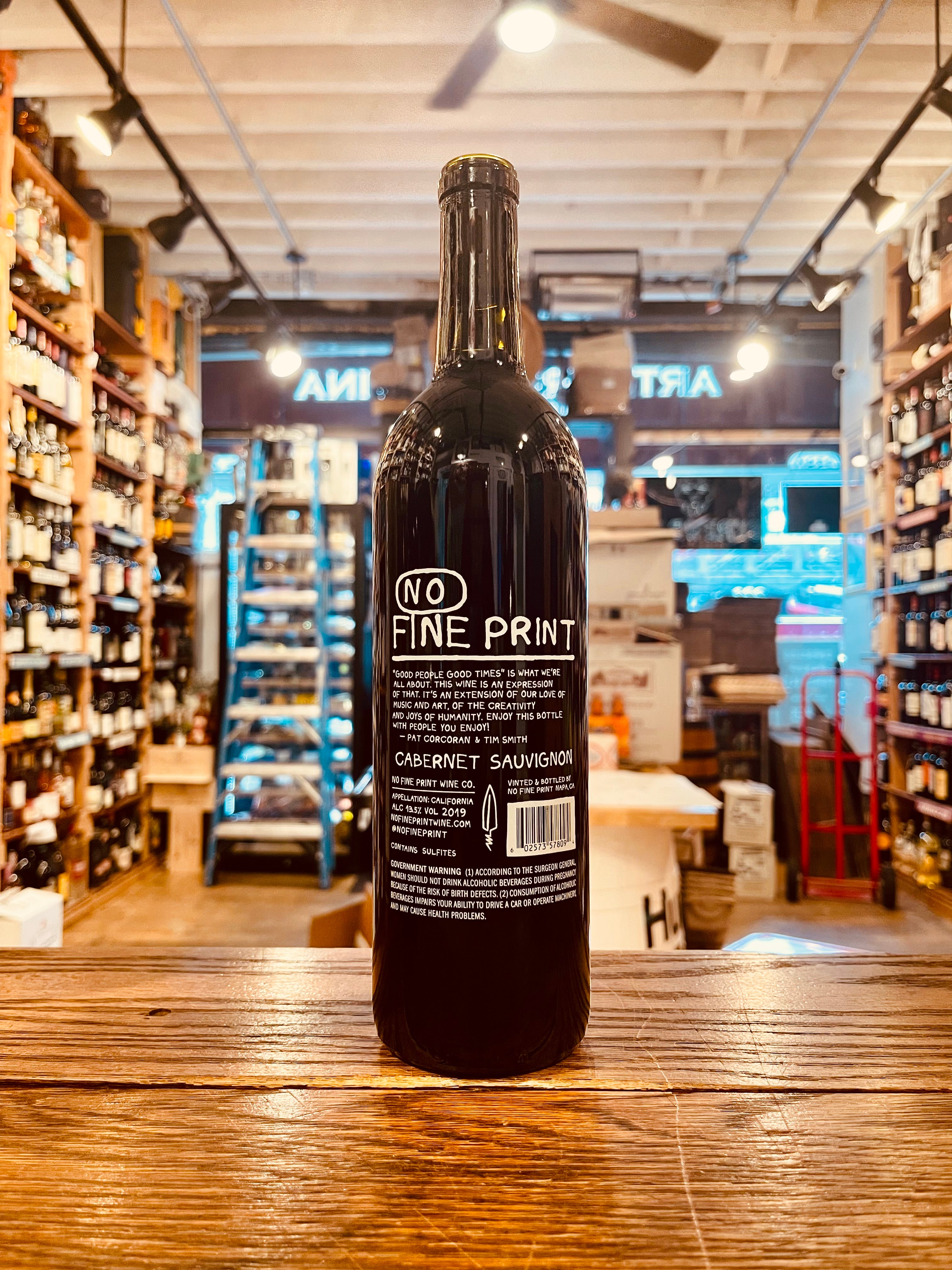 No Fine Print Cabernet 750mL backside of a dark glass wine bottle with white font and a black top