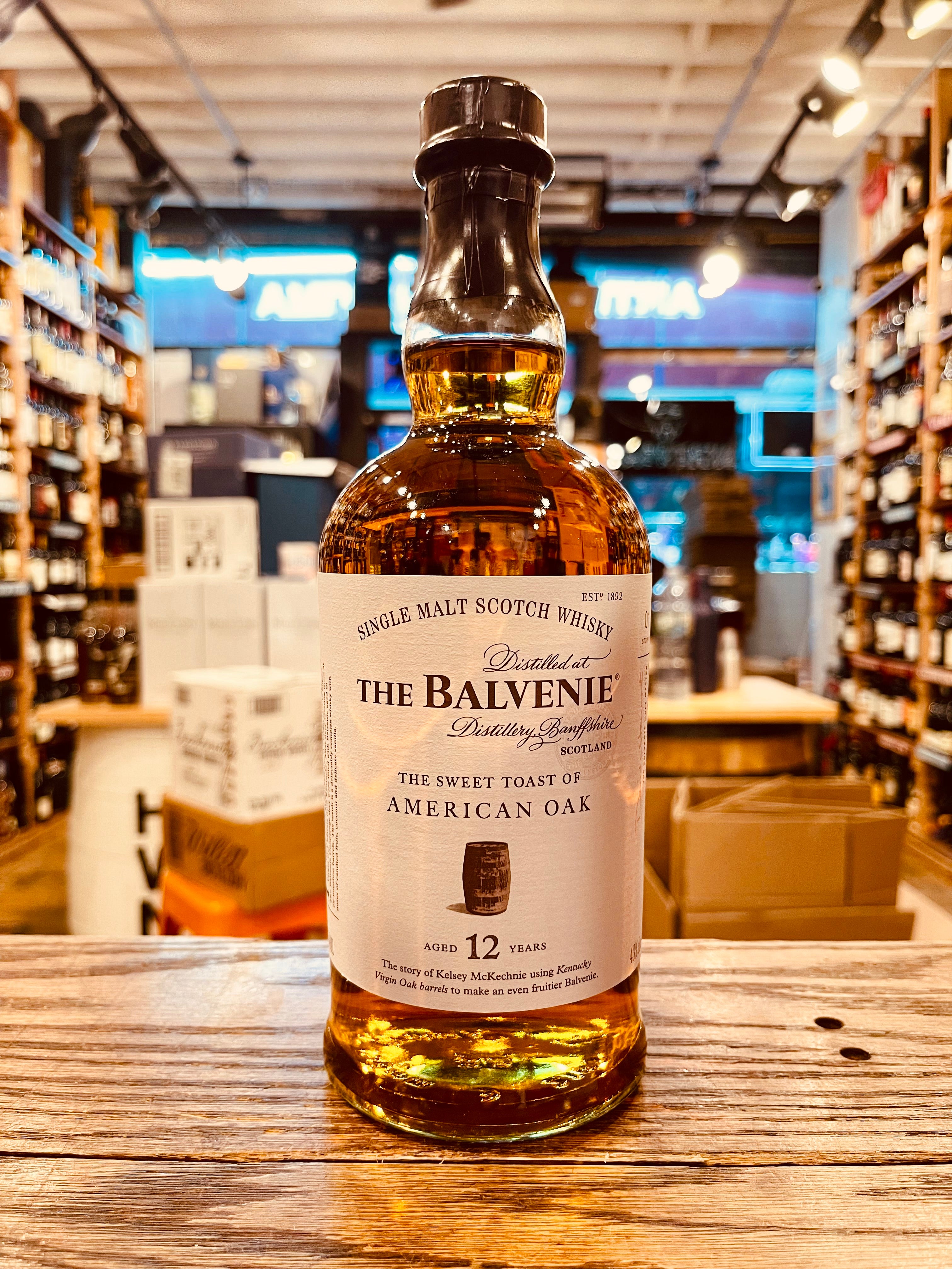 The Balvenie 12Yr The Sweet Toast of American Oak 750mL the round robust clear glass bottle with a white label and a black top