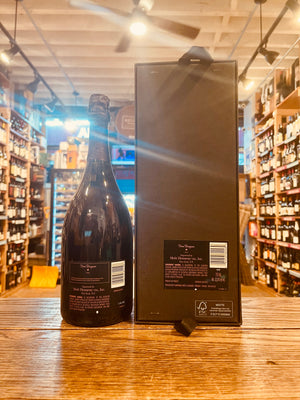 Dom Perignon Rose Gift 2006 750mL the back side of a dark champagne bottle with black and rose colored labeling next to a tall black box with black and rose labeling