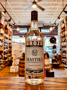 Grozd Strumica Mastika 1L a stout clear bottle with a light blue label and dark blue top
