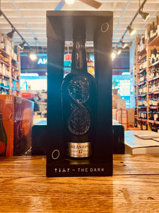 Highland Park 17 Dark Edition 750mL 52.9º a tall black open faced wooden box with a tall black glass bottle inside of it with a ancient looking symbol etched onto the bottle