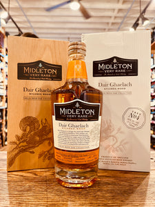 Midleton Very Rare Whiskey Dair Ghaelach Kylebeg Wood Tree No4 700mL a clear high shouldered rounded glass bottle with a white label and wooden top in front a of wooden box with an image of a squirrel next to a white cardboard box with the same image