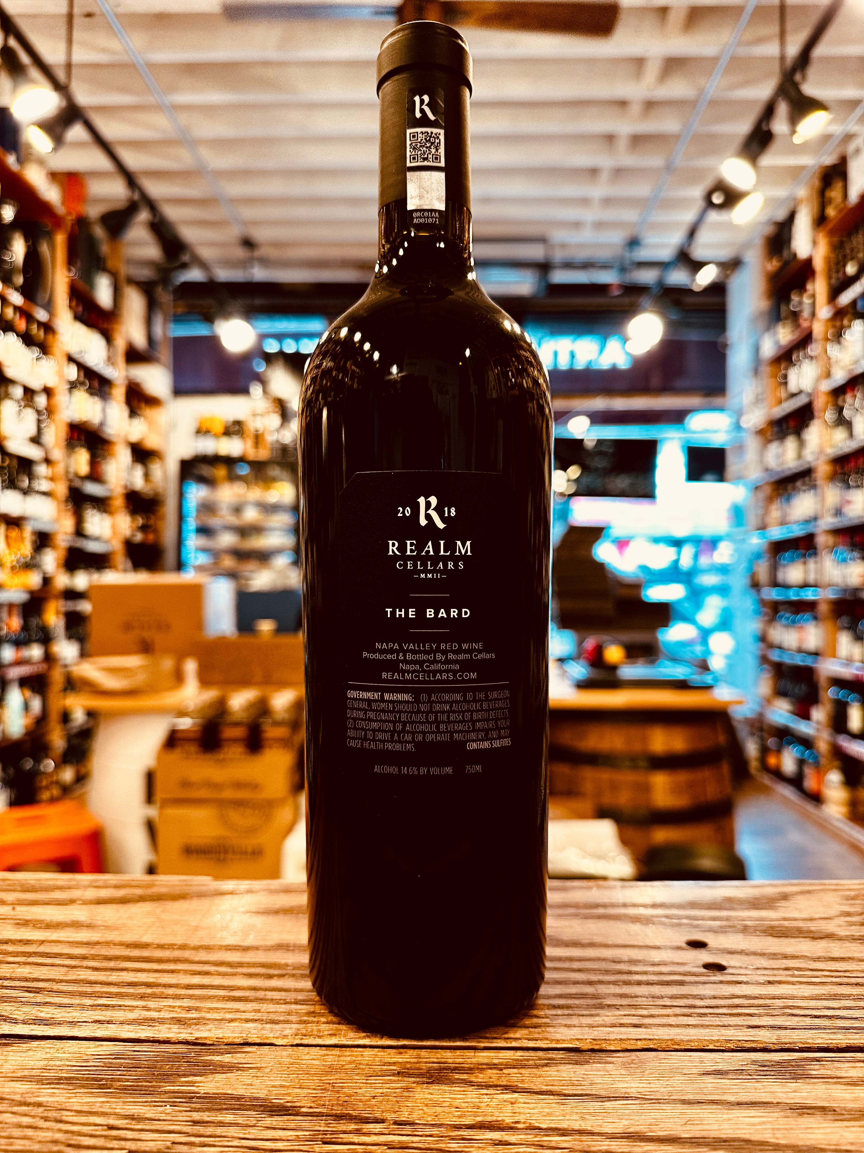 Realm The Bard Napa Valley 750mL the backside of a tall dark glass wine bottle with a black label and a black top