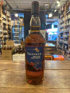 Talisker Distillers Edition Single Malt Whisky 750mL a tall round shouldered clear glass bottle with a blue label and a dark blue top