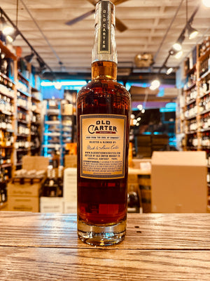 Old Carter Straight Rye Whiskey Batch #10 750mL the backside of a tall clear glass bottle with a beige label and wooden top