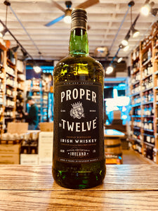 Proper Twelve 12 1.75L a large green glass bottle with a black label and a black top