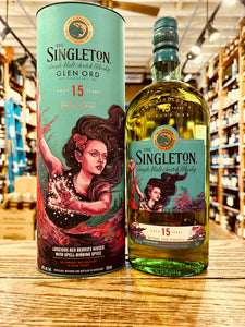 Singleton Glen Ord 15Yr Scotch Whisky 750mL a tall aqua colored tin cylinder with the image of a mermaid next to a flat surfaced rounded shouldered clear glass bottle with an aqua label and the image of a mermaid with a aqua green top