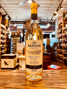 Nardini Riserva 3Yr Bassano 700mL a tall slender clear glass bottle with a white label and golden top