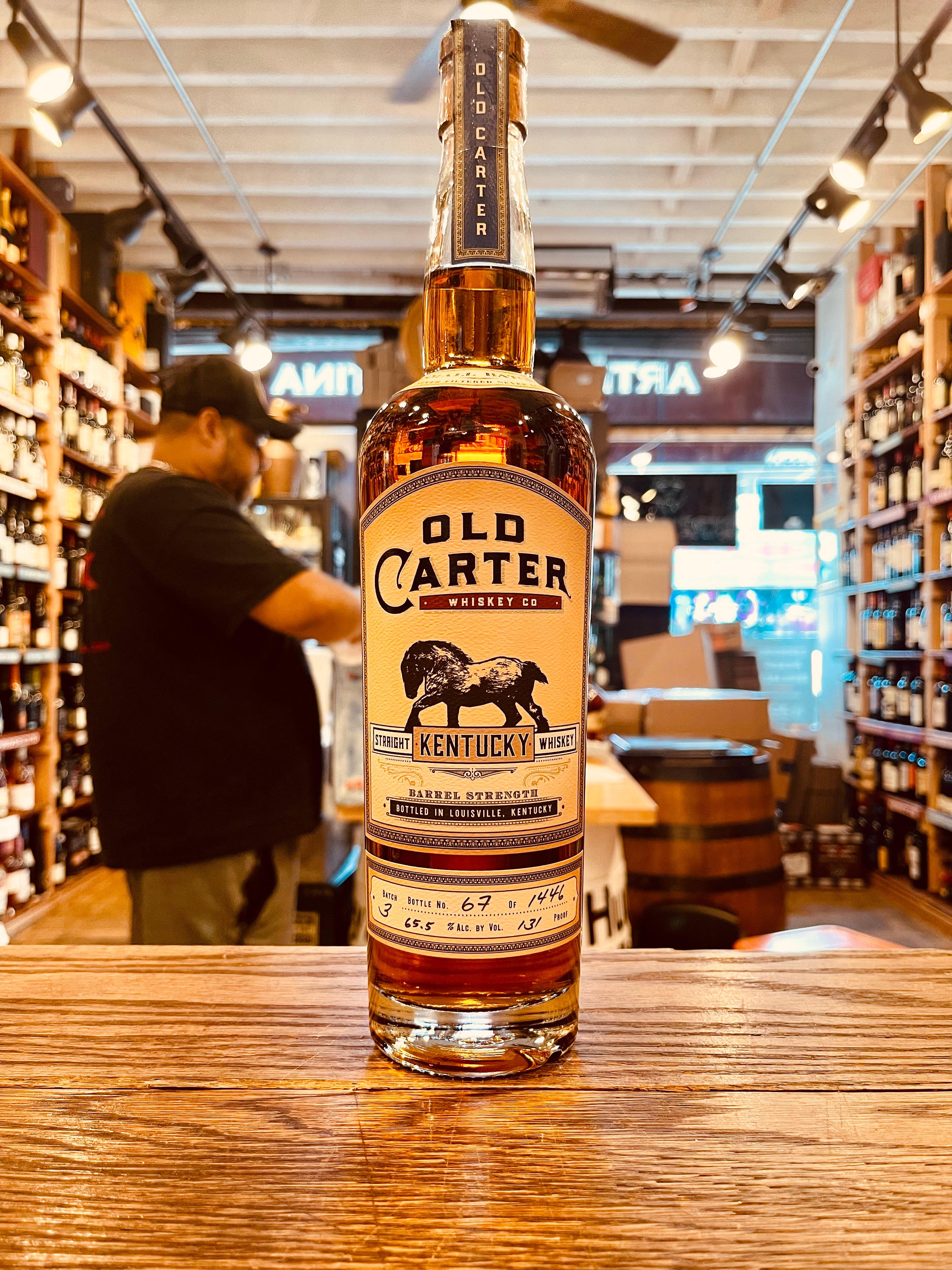 Old Carter Straight Kentucky Whiskey Barrel Strength Batch 3 750mL a tall clear glass bottle with a beige label and the image of a horse with a wooden top