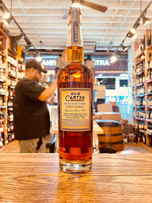 Old Carter Straight Kentucky Whiskey Barrel Strength Batch 3 750mL the backside of a tall clear glass bottle with a beige label and wooden top