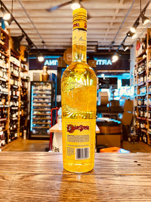 Strega Liquore 750mL the backside of a tall high shouldered long necked clear glass bottle with a yellow label and yellow top