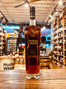 Thomas S. Moore Madeira Cask 750mL a tall slim squared clear glass bottle with gold lettering and an image of a horse and a black top