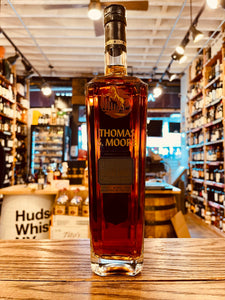 Thomas S. Moore Merlot Cask 750mL a tall slim squared clear glass bottle with gold lettering and an image of a horse and a black top