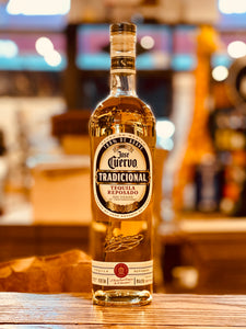 Jose Cuervo Tradicional Reposado 750mL a tall round shouldered clear glass bottle with a white label and wooden top