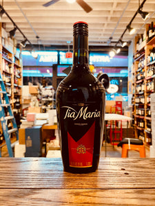 Tia Maria 1L a dark robust rounded glass bottle with a red and black label and red and black top