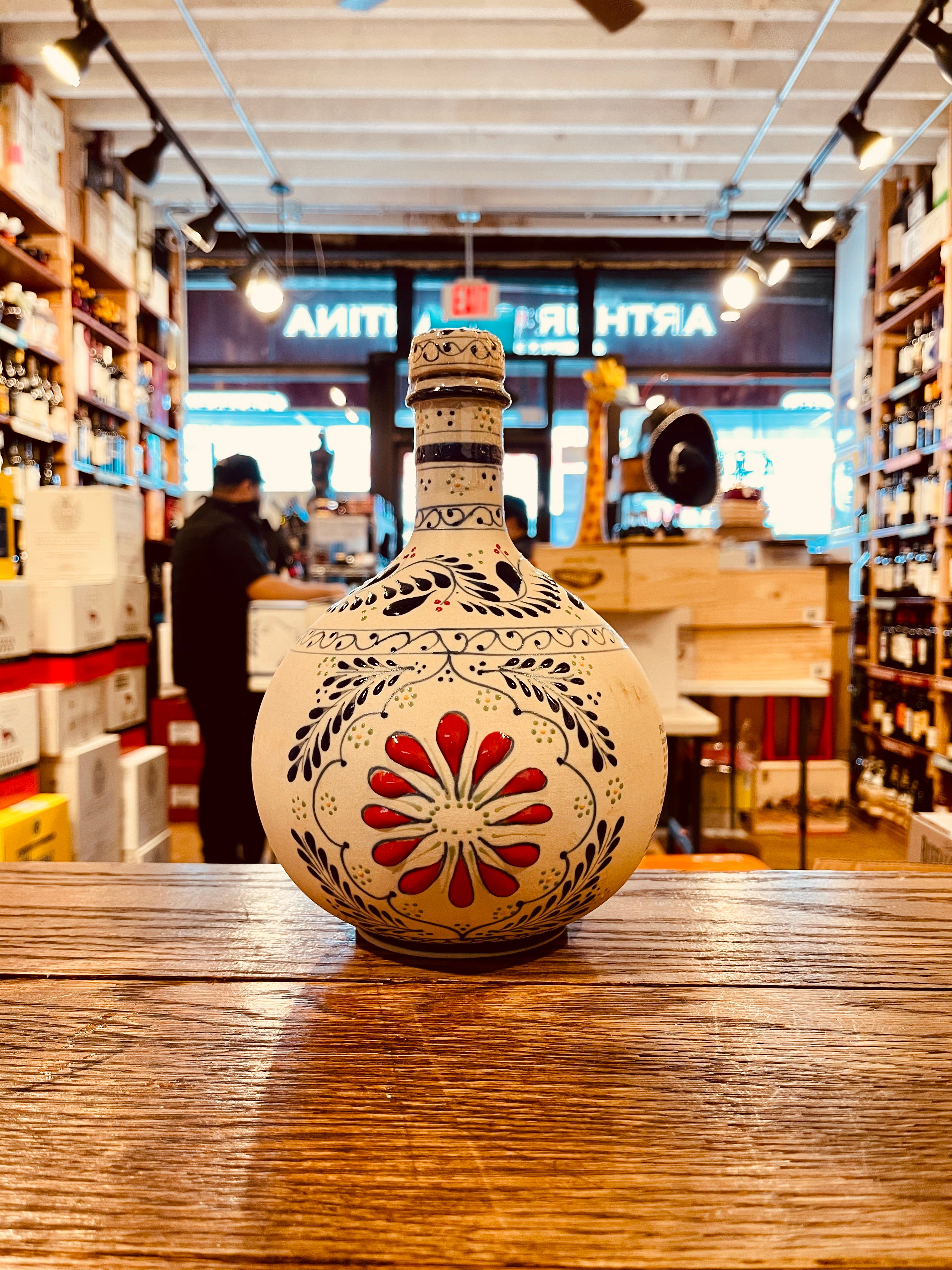 Grand Mayan Extra Aged Tequila 1.75L a hand craft  ceramic rounded bottle hand painted bright red and blue design. 