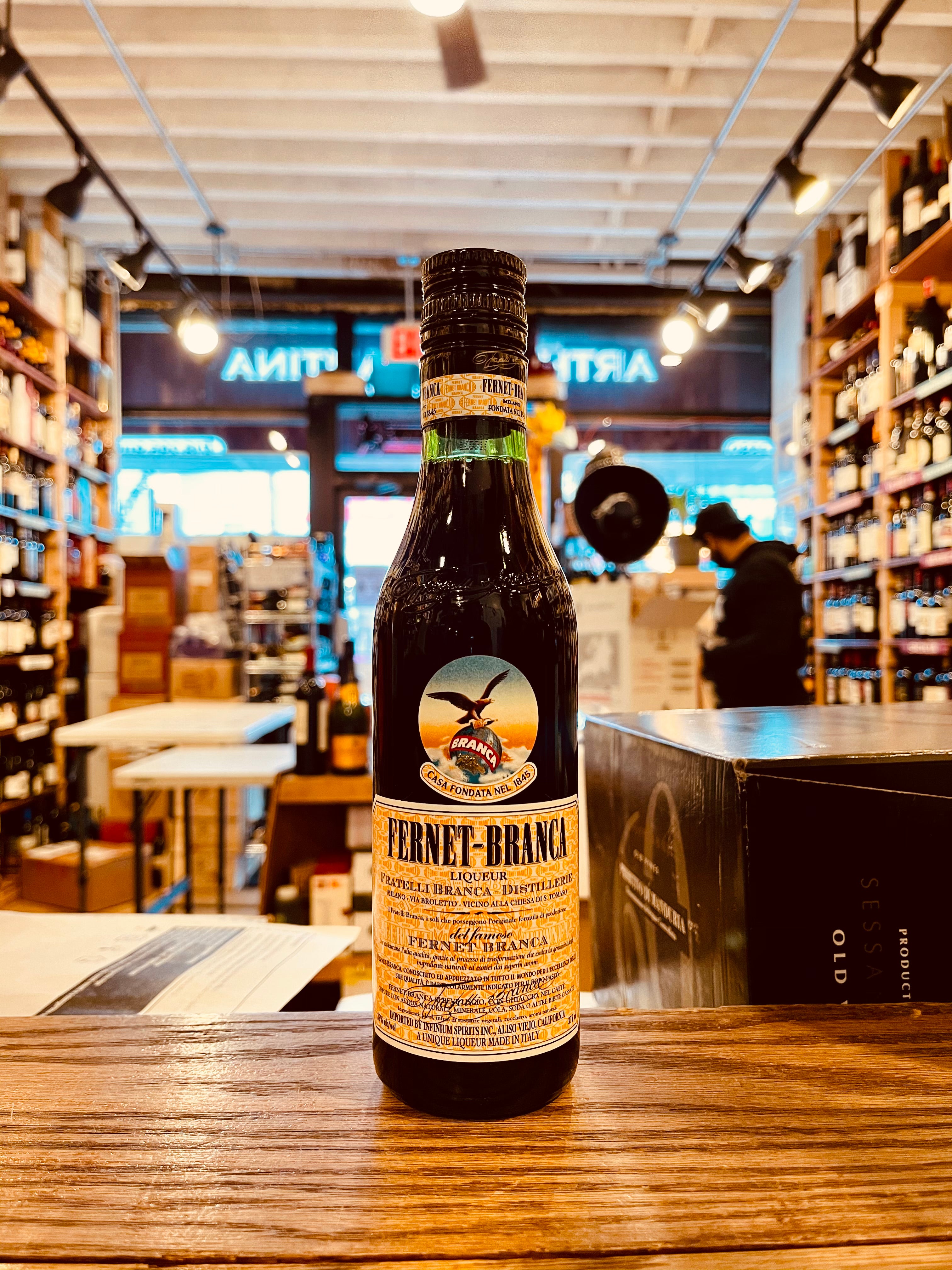 Fernet Branca 375mL a small dark green bottle with a beige label and image of an eagle with a black top