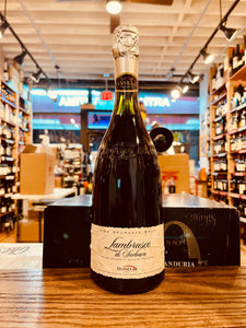Donelli Lambrusco Sorbara 750mL a dark champagne bottle with a white label and silver top