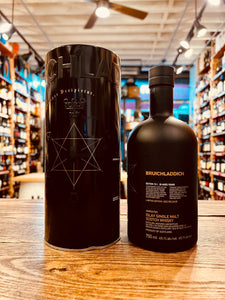 Bruichladdich Black Art 10.1 750mL a black tin canister next to a black rounded bottle 