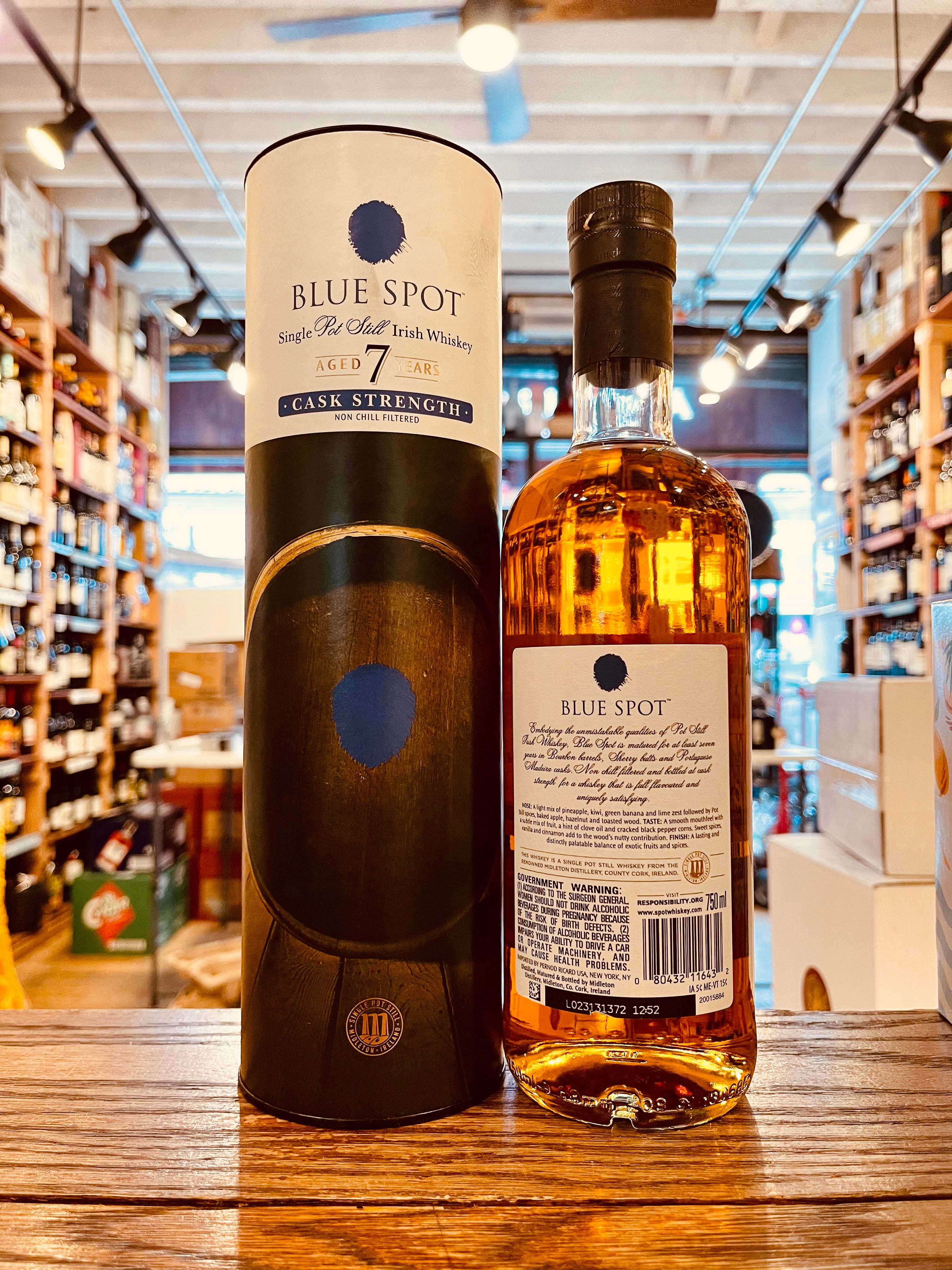 Blue Spot 7 Year Old Cask Strength 750mL a white and dark colored cylinder next to a clear bottle with a white label and blue spot