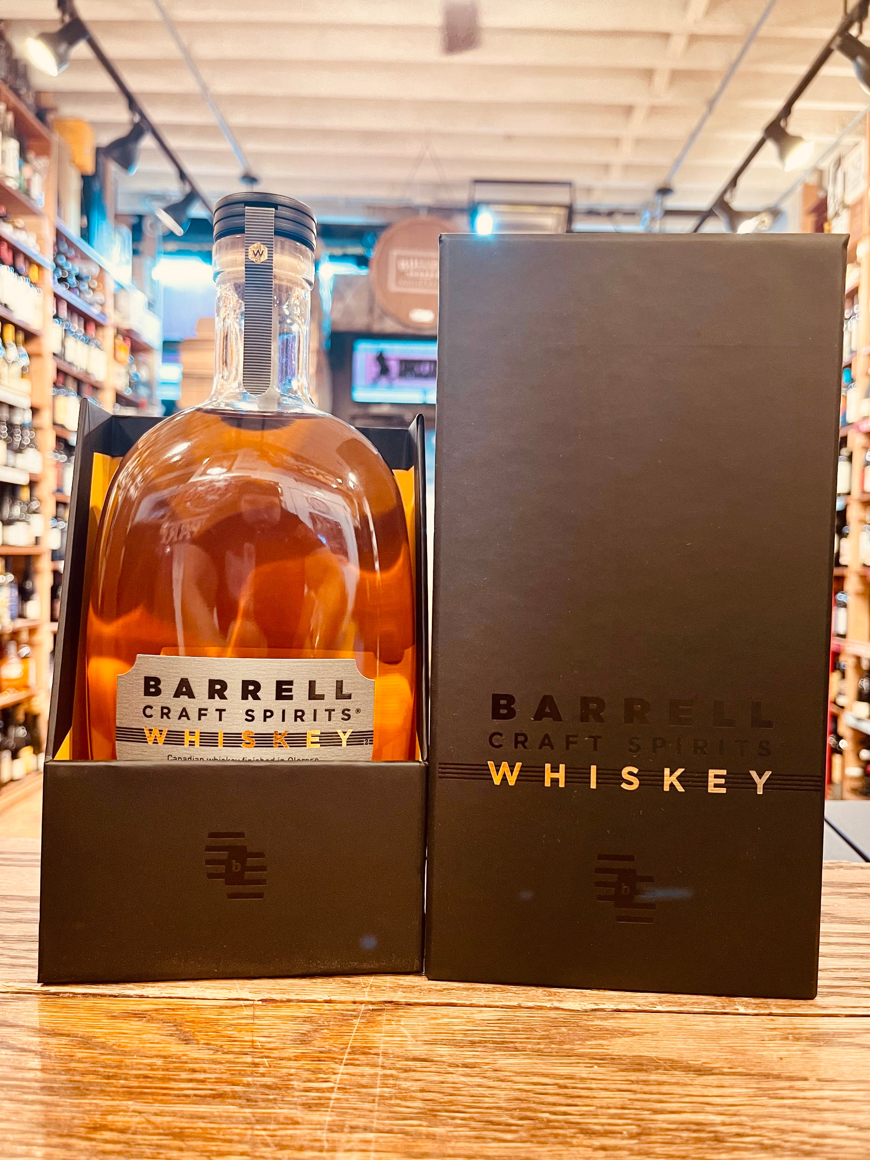 Barrell Craft Spirits Whiskey (Gray Label) black box with reflective and gold lettering with an oval shaped clear bottel inside with silver labeling 