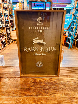 Codigo 1530 Playboy Rare Hare Añejo Tequila Gift Set 750ml a wooden box with a glass clear cover with white lettering and an image of a hare on it