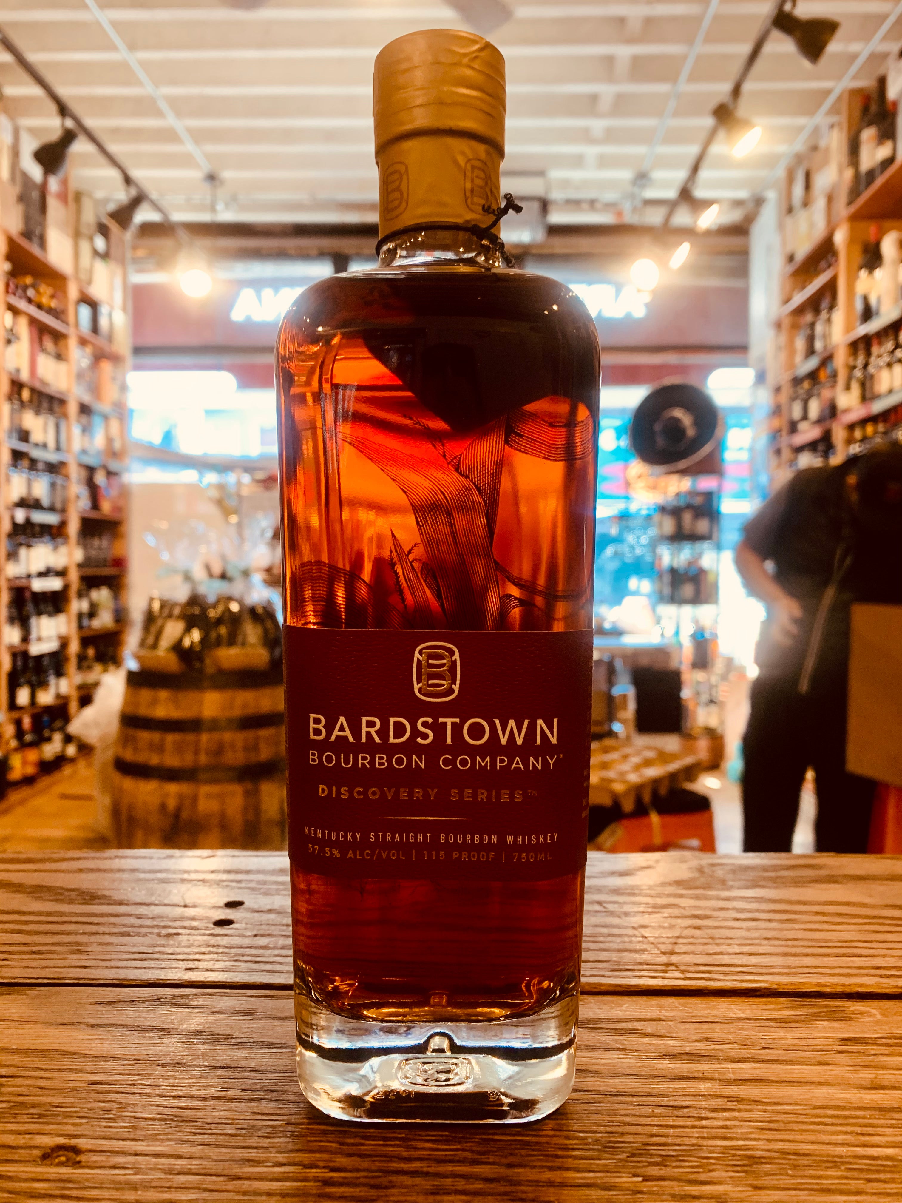 Bardstown Bourbon Discovery 750mL a squared clear bottle with a gold top and maroon label
