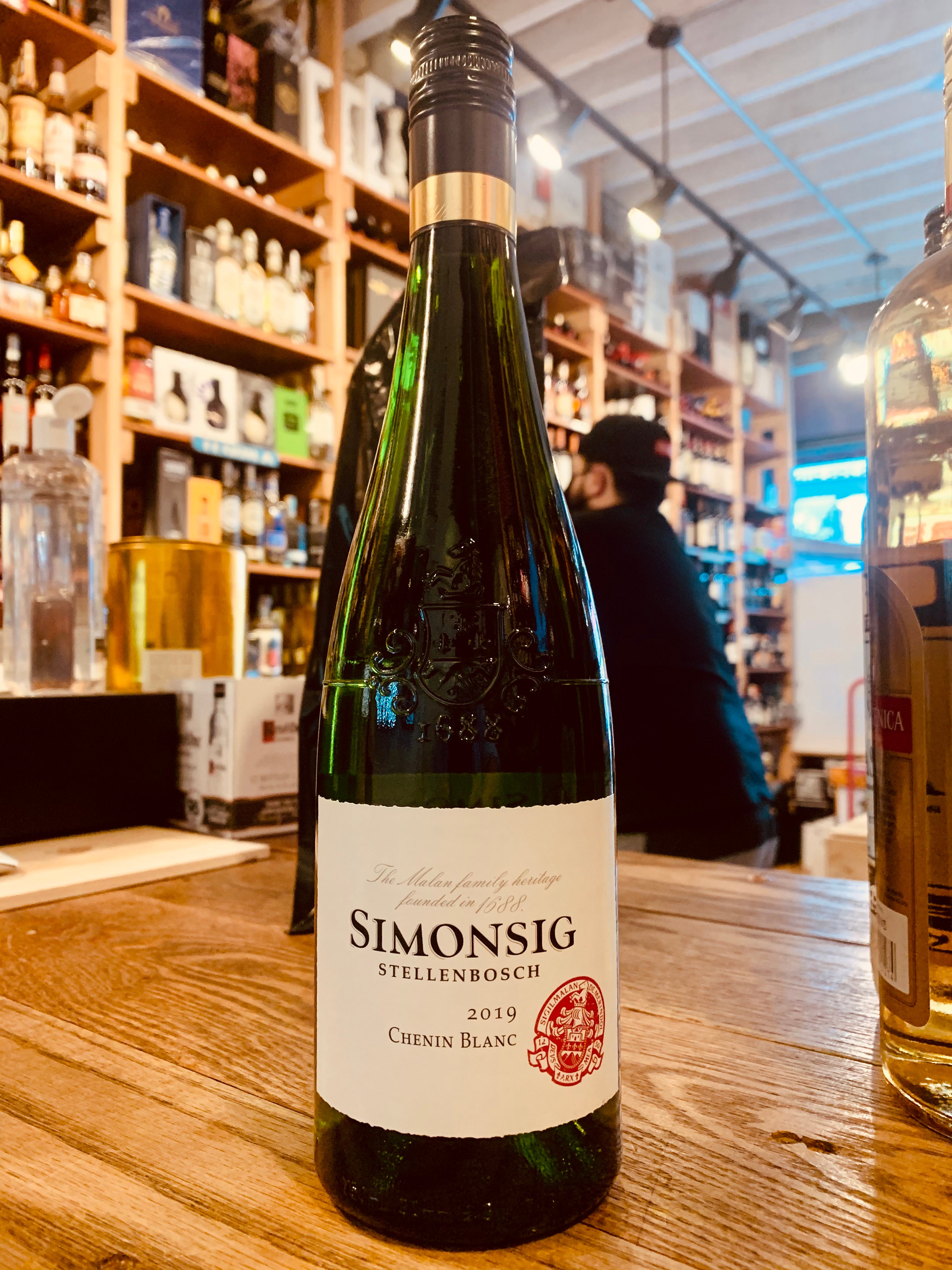 Simonsig Chenin Blanc 2019 750mL a green glass wine bottle with a white label and a black top