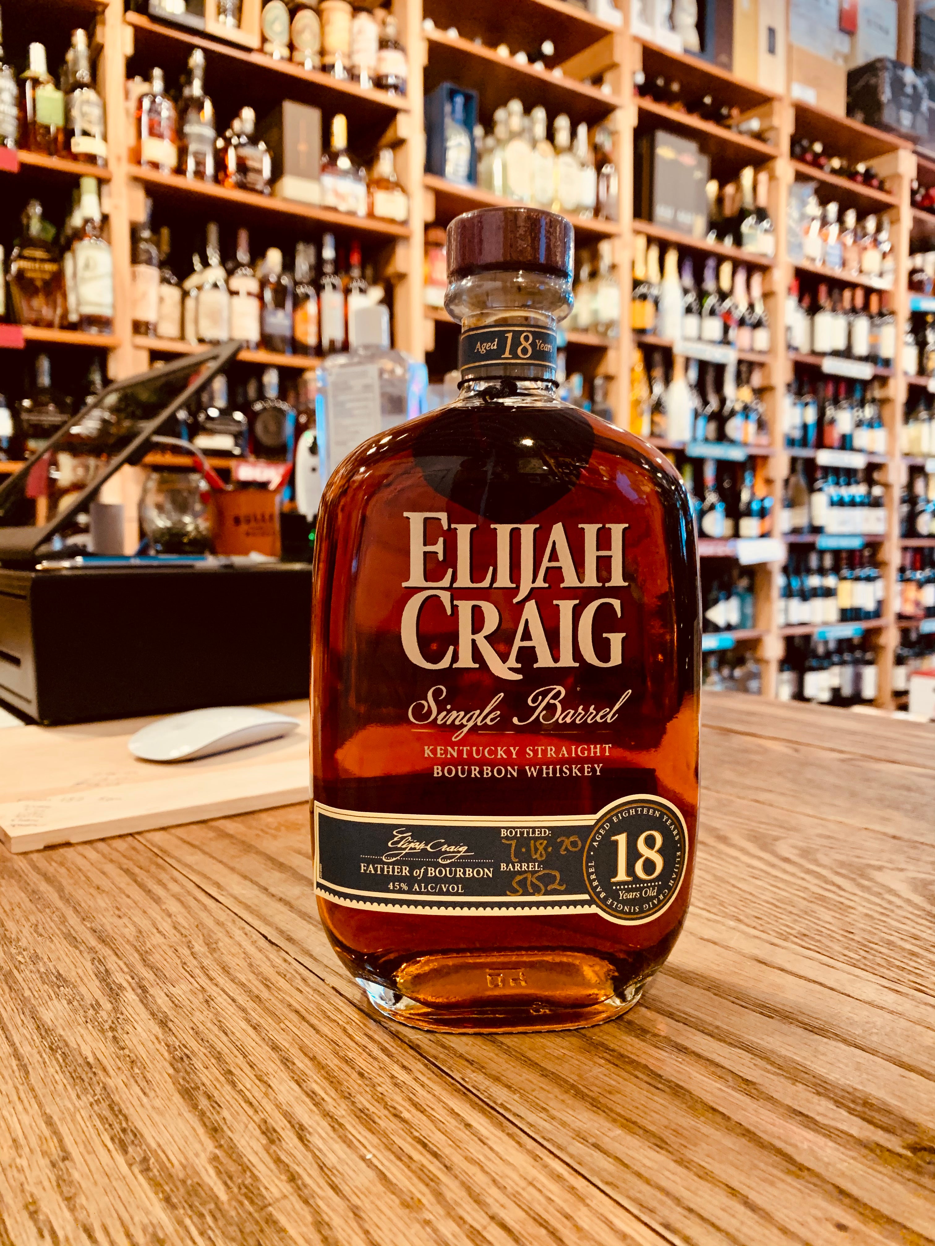 Elijah Craig Single Barrel 18yr old 750mL flat rounded bottle with white lettering and a wooden top