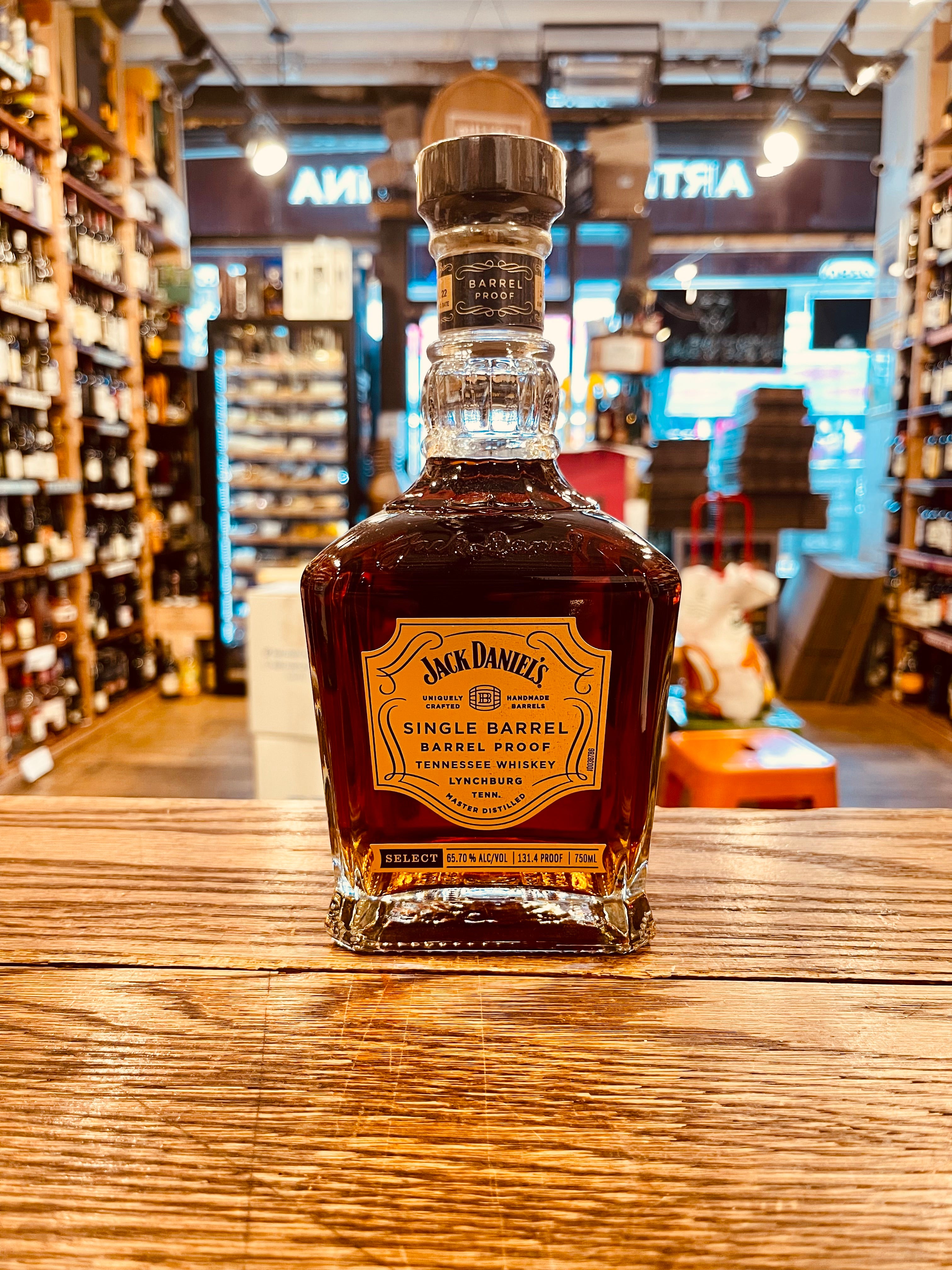 Jack Daniel's Single Barrel 750mL 131.4º a short squared long neck clear glass bottle with a golden label and wooden top