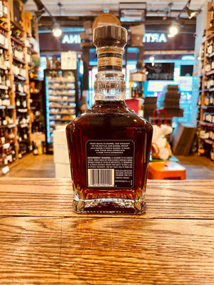 Jack Daniel's Single Barrel 750mL 131.4º backside of a short squared long neck clear glass bottle with a black label and wooden top